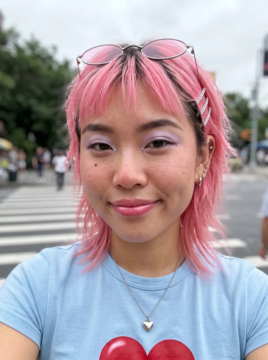 AI-generated sample input: front-facing selfie of a woman with a pink shag haircut, rhinestone hair clips and pink glasses pushed up, in a light blue heart T-shirt at a crosswalk