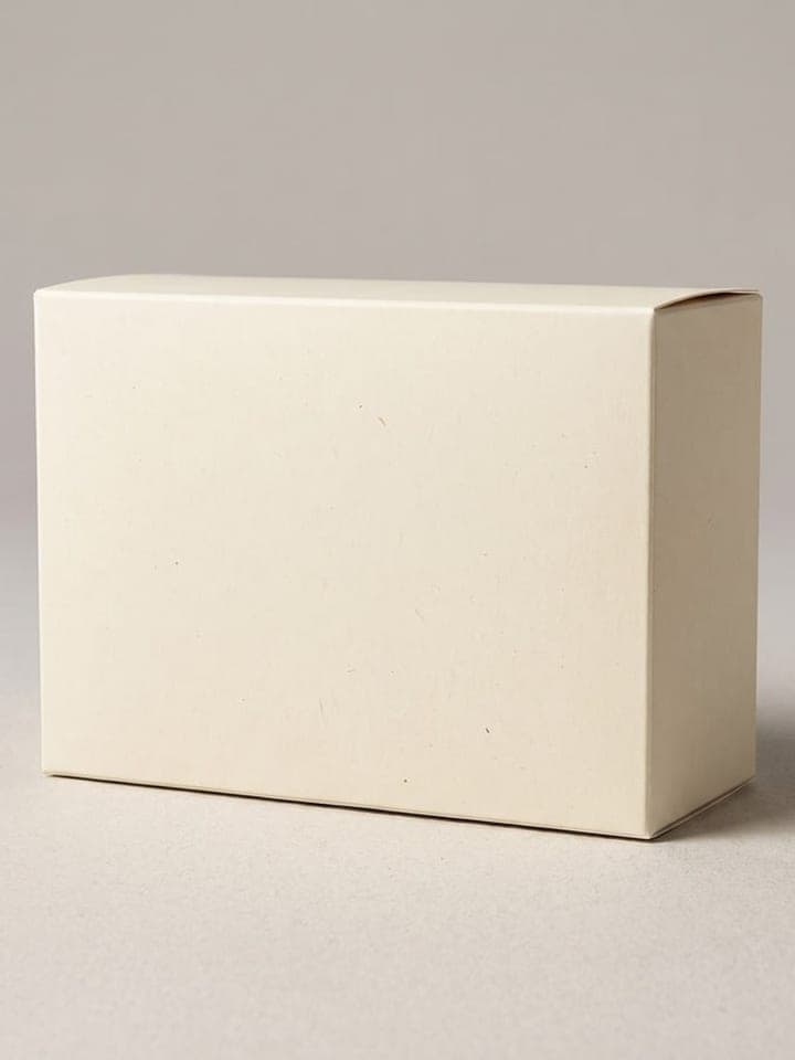 Plain cream cardboard box on a neutral background with a soft shadow, presentation angle