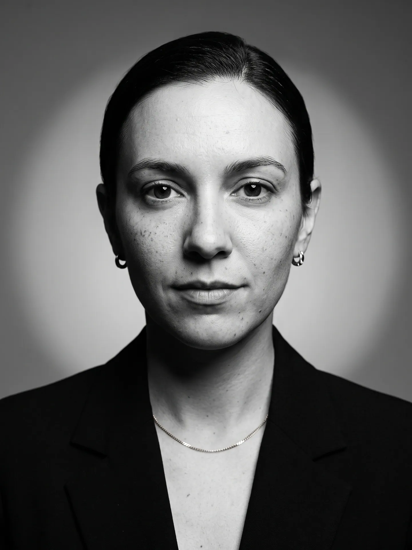 Monochrome portrait of a woman in a black blazer, made with the Black-and-White Portrait template from a selfie
